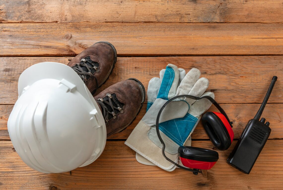 Work safety, labor personal protective gear on wood. Industry and construction site equipment..