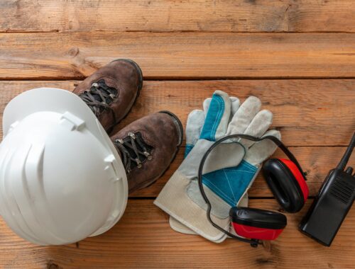 Work safety, labor personal protective gear on wood. Industry and construction site equipment..