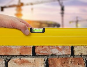 Worker Using Level On Building Site - concept.