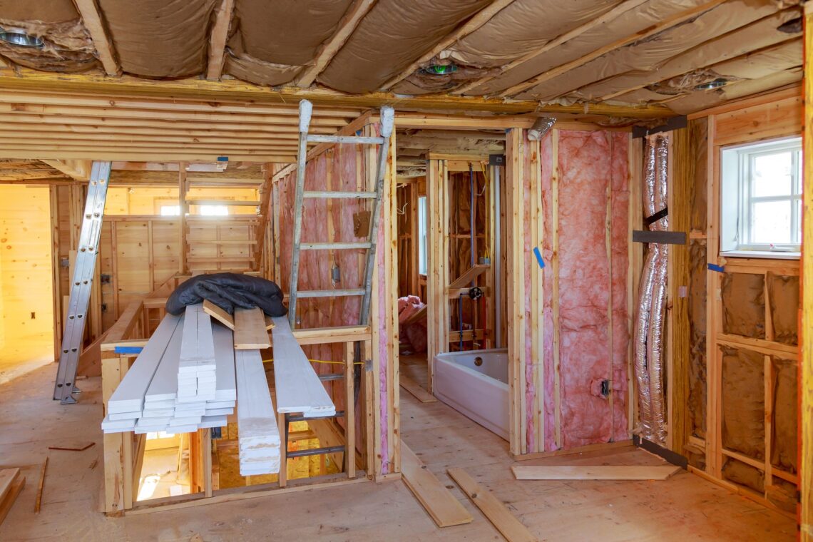 Mineral glass wool in a warming the walls with fiberglass on a inclined wall near the wooden ceiling
