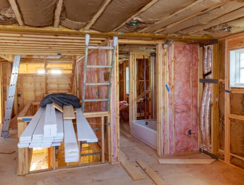 Mineral glass wool in a warming the walls with fiberglass on a inclined wall near the wooden ceiling